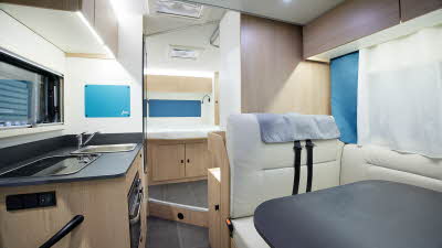 Coachbuit interior, cream upholstery, wooden furniture