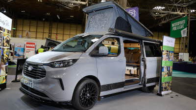 The Knights Custom Conversion Prestige Tourer Plus is grey. The sliding door is open and its rising roof is fully extended.