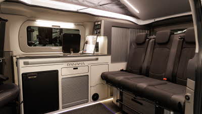 The Panama P\10E has black upholstery and silver tambour doors on the cabinets.  The fridge is black.  Its rising roof is open.