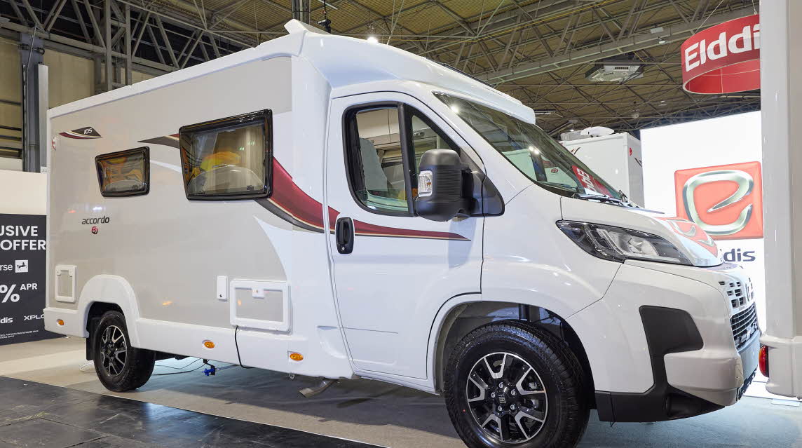 The Elddis Accordo 105 has a white body with a grey side panel.  There are red and black decals.  