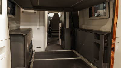 TheAdria Twin Supreme 640 SGX's drop down bed has two white mechanisms on the rear wall.