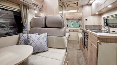 Coachbuilt interior, cream upholstery, wooden furniture