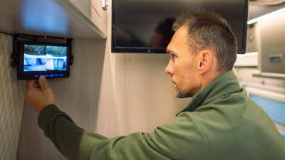 Man checking CCTV inside a motorhome