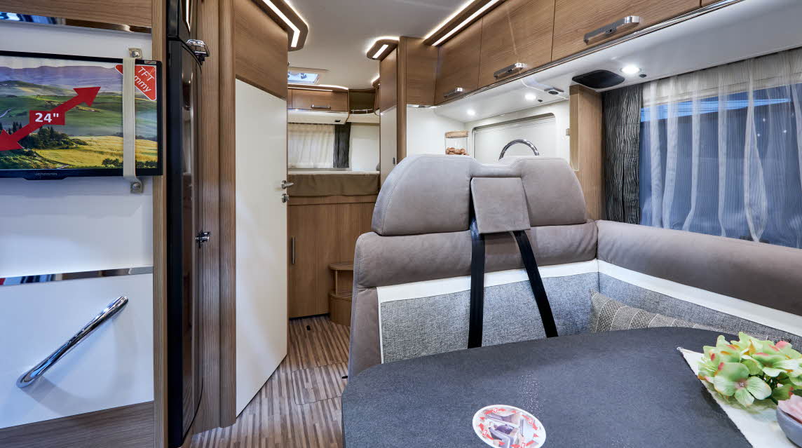 Interior, stripy floor, cream upholstery, wooden cabinets 