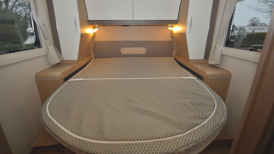 Spacious double bed in beige colour scheme