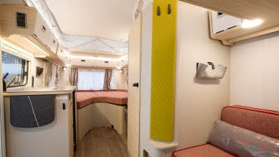Eriba Touring 542 interior, salmon upholstery, lounge, kitchen, fixed bed