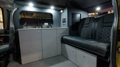The Bespoke Explore has black upholstery with grey walls and white cabinets.