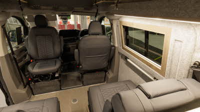 The Hillside Leisure Cromford has dark brown upholstery with a beige floor, its rising roof is open.