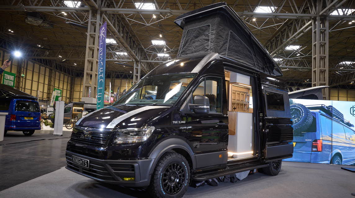 The Knights Custom Conversion Prestige XL is black.  The sliding door is open and its rising roof is fully extended.