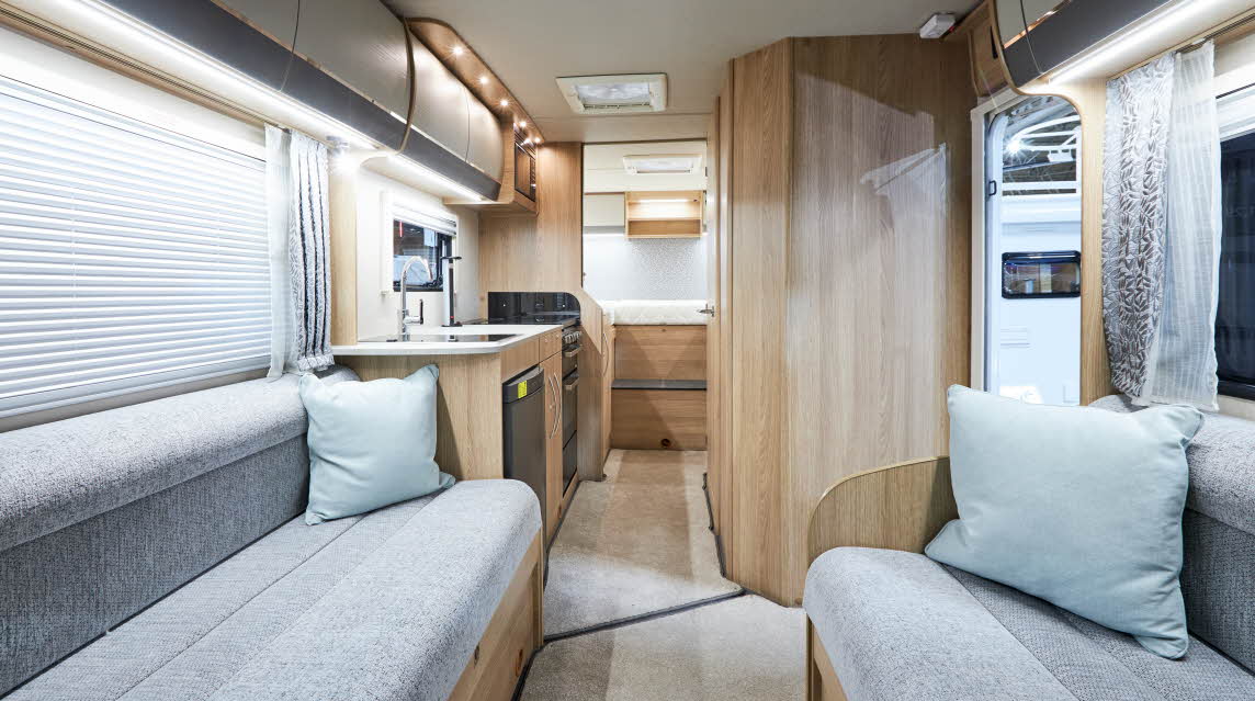 Interior, grey sofas, wood cupboards, pale blue cushions