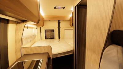 The Rimor Horus 54 has a rear fixed bed.  The panelling is wooden and the kitchen is to the front left.