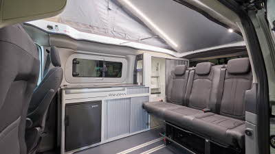 The Panama P-12 has grey flooring with grey upholstery.  Its rising roof is fully open.