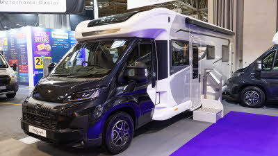 The Bailey Autograph 81-5 has a black cab with a white and grey coachbuilt body.  It has a step next to the habitation door.