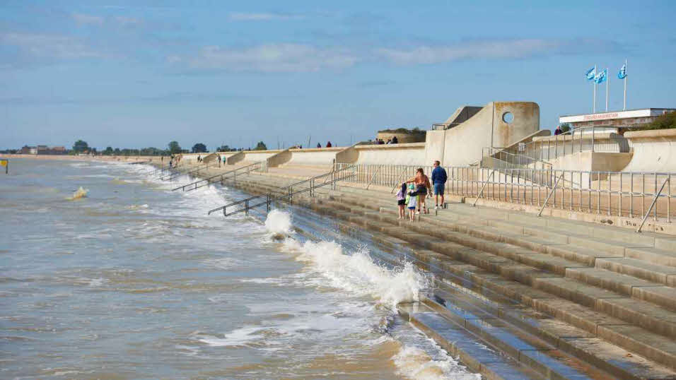 Family strolling along the beach at Dymchurch