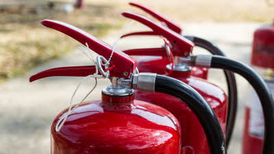 a row of red fire extinguishers