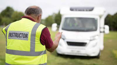 Instructor showing a motorhome how to manoeuver