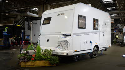 Knaus Yaseo 340 PX exterior is white and it has a small square front window in the left hand middle panel.  There are grey honeycomb patterned panel at the front.. 