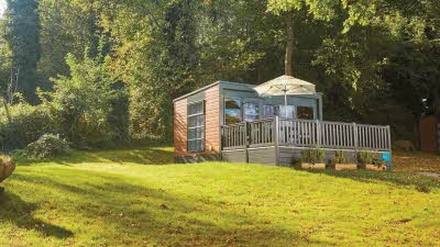 Glamping pod on a grassy hill in Autumn
