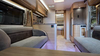 Bailey Alicanto Grande Porto interior, grey upholstery, wood/cream and wood overhead lockers, lounge, kitchen and bedroom, fixed bed, two skylights