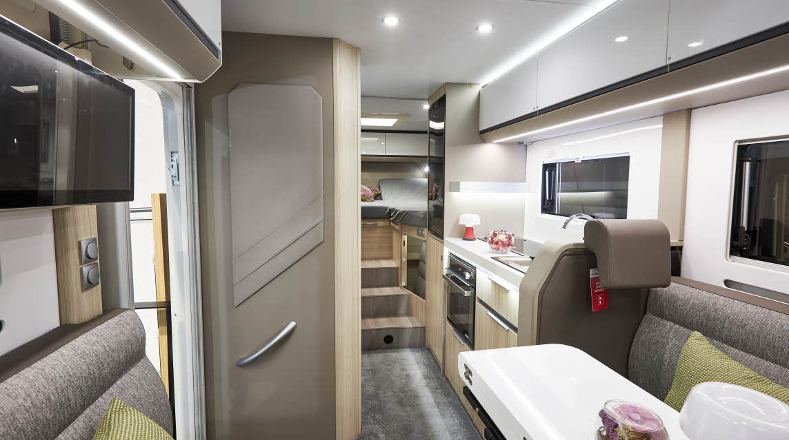 Grey upholstery, white overhead lockers, lime cushions