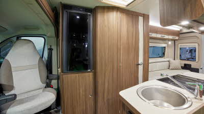 White and wood interior, kitchen sink, black fridge