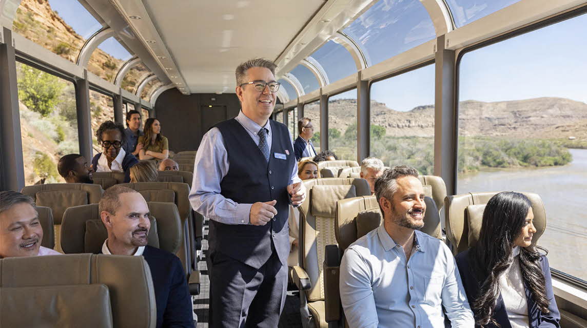 Interior shot of the Rocky Mountaineer with people enjoying the views