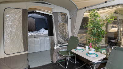 Campmaster 600LX interior, separate bedroom compartment, dining area, brown groundsheet