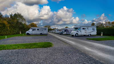 A campsite landscape shot with motorhomes on pitches