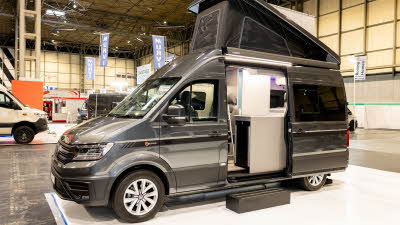 The Bespoke Leisure Bespoke Zermatt Edition is grey, its rising roof and sliding door are open.  There is a step to enable easy access.