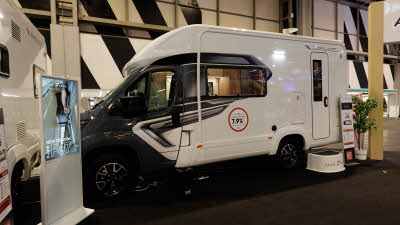 The Auto-Trail Imala 615 has a dark grey cab with a white coachbuilt body, there is a step outside the main door to gain easy access.