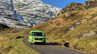 Green Flag van travelling on a small mountain road
