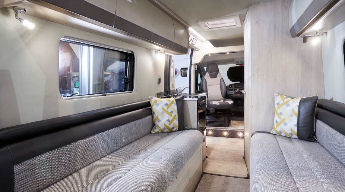 Interior, two tone grey sofas, patterned cushions, ground level lighting