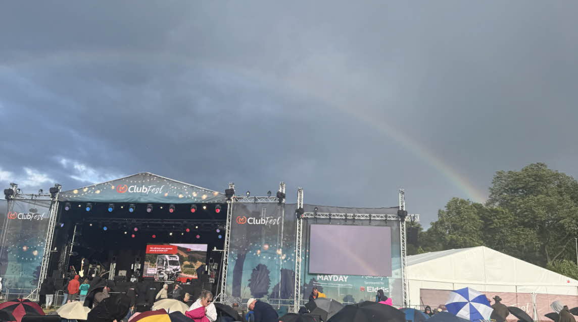 a rainbow arcs over the ClubFest stage