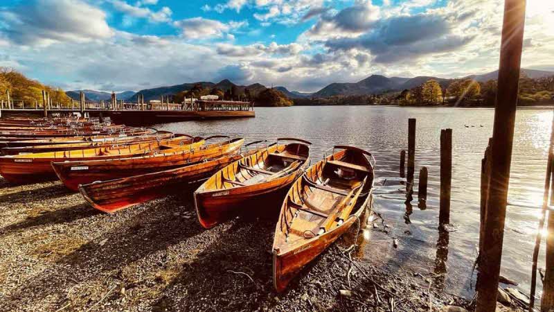 Wooden boats on shingle beach at the edge of the water
