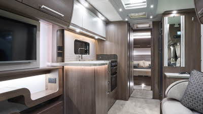 Buccaneer Barracuda interior, cream upholstery, dark wood furniture, white kitchen overhead lockers, lounge, kitchen, bedroom, fixed bed, three skylights