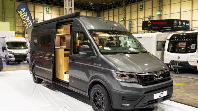 The Mega Mobil Mega Re-Aktiv 680S 4X4 is grey and its sliding door is open.