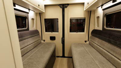 The Ace Motorhomes 1200 RL has mid and dark brown upholstery on the two rear sofas, there are two rear doors.