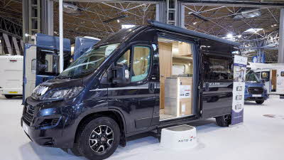 Auto-Trail V-Line 610 Sport exterior, the vehicle is back, the sliding door is open showing into the interior, with a step to gain easy access.