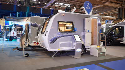 Bailey Discovery D4-2 exterior which is pale grey.  The door is open and there are steps to gain easy access to the interior.  The round sticker on the roof advises the audience it is a two berth.