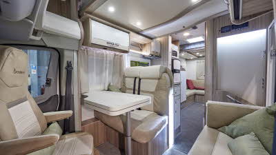 Benimar Tessoro 481 has pale upholstery, with white overhead lockers.   It has grey carpets and has a rear lounge.