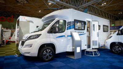 Exterior, coachbuilt motorhome, white with blue/grey accent stripes