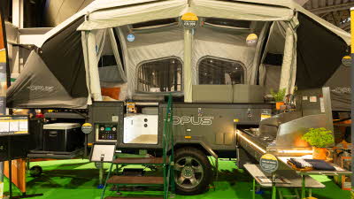 The OPUS ORX has two tone brown and cream canvas.  There is a kitchen unit to the right.  There are three steps up to the unit.