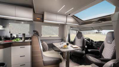 The Adria Matrix Supreme 670 SC has brown and beige upholstery, it has matching cabinets.  The front seats are swivelled and join the dining area.  There is a huge sunroof above the cab.