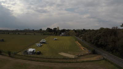 Open field with four caravans pitched up