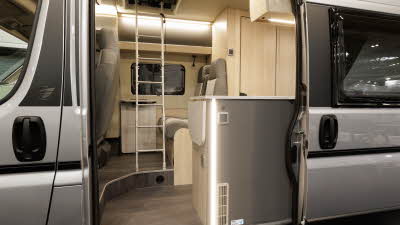 The Auto-Trail Expedition 67 has beige and cream upholstery with pale wood furniture.  There is a ladder to enable easy access to the roof bed.
