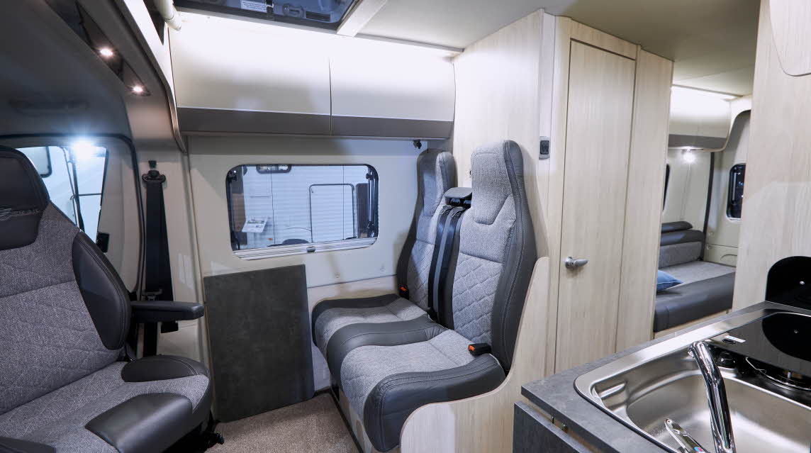 Interior, light wood cupboards, grey upholstery, kitchen sink