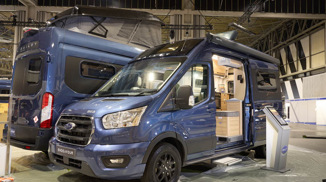 The Bailey Endeavour B63 is blue with black trim.  There is an interactive stand by the open sliding door which reveals the interior.  