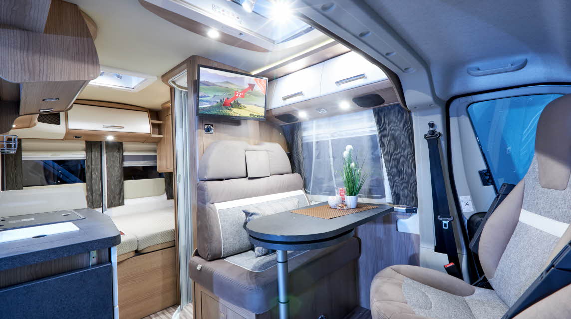 Van conversion, beige upholstery, grey table, skylight
