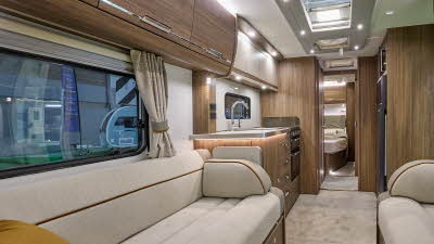 Compass Camino 668 interior, cream upholstery, dark wood furniture, skylights
