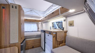 Eriba Touring 310 interior, grey upholstery, wood furniture, pop top roof, lounge, kitchen